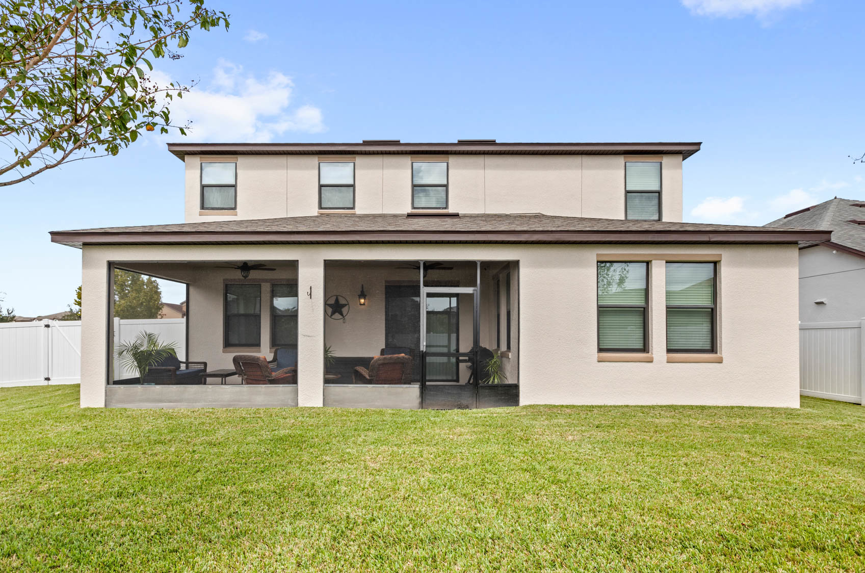 back of two story home with screened in patio
